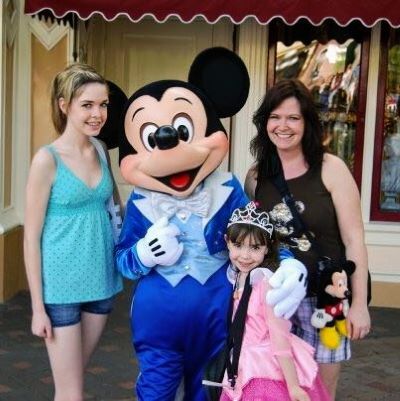 Me and my girls with Mickey Mouse at Disneyland in California
