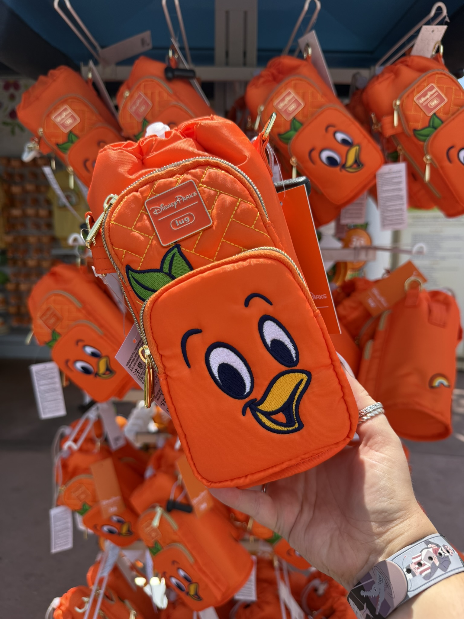 Orange Bird mini backpack-style pouch display at EPCOT Flower & Garden Festival merchandise shop