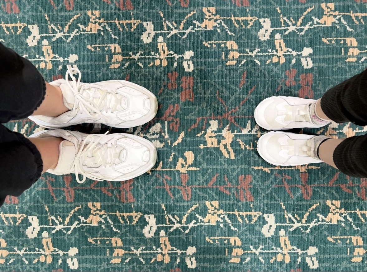 Parent and toddler wearing running shoes at Orlando International Airport