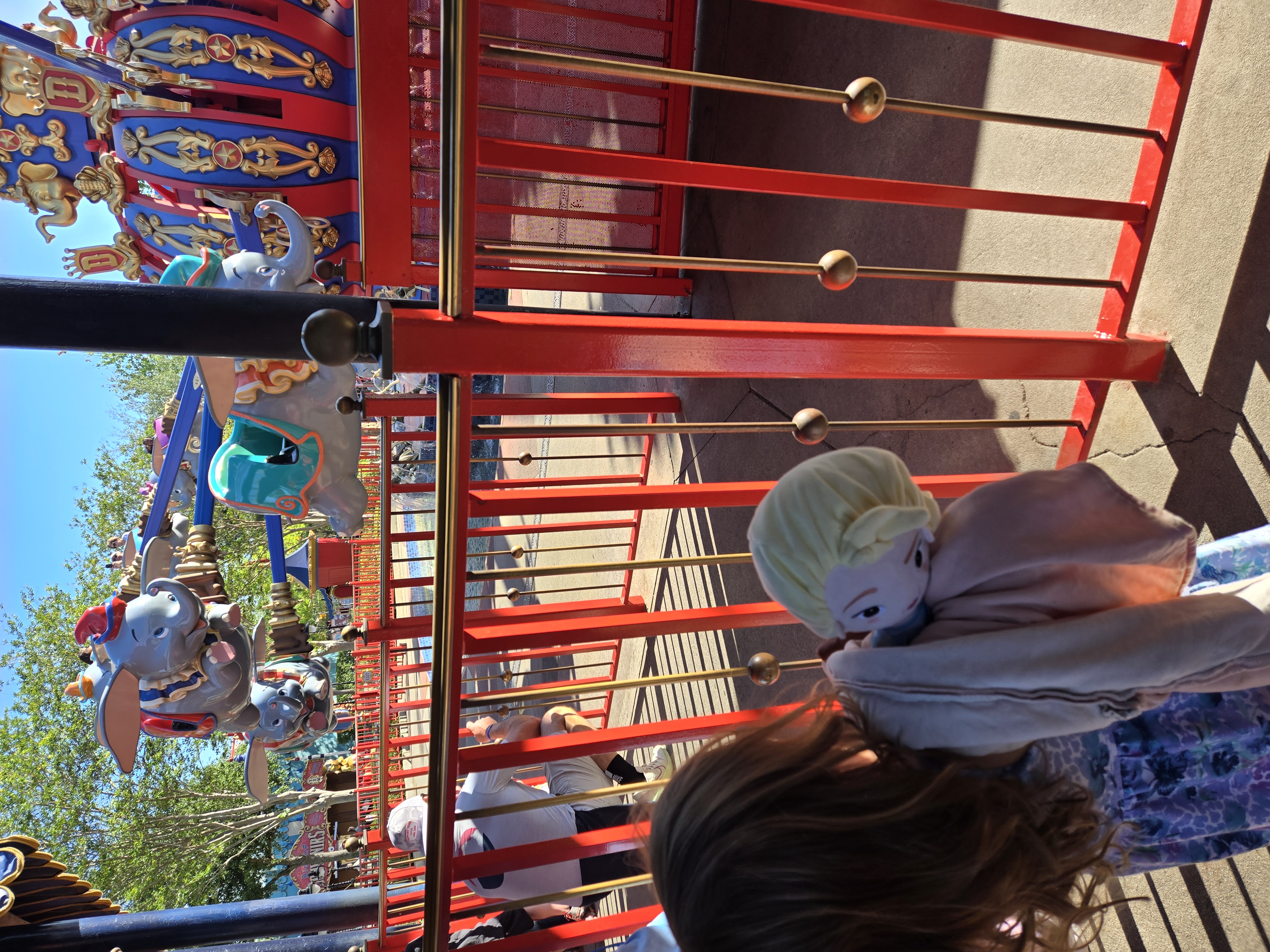 Child watching Dumbo the Flying Elephant ride at Walt Disney World during a family vacation day