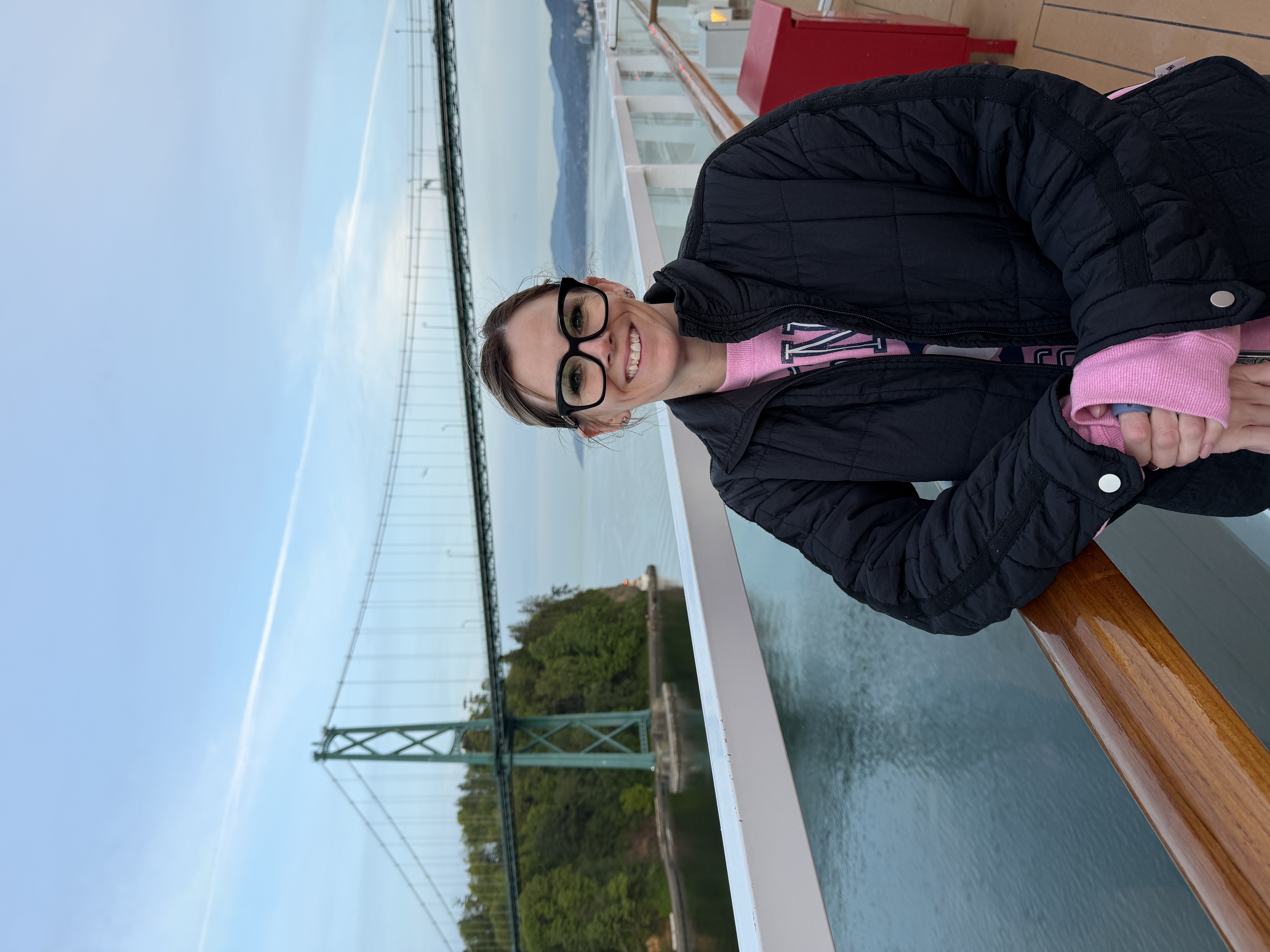 Pure Magic Vacations advisor Mandy standing on deck with the Lions Gate Bridge behind her.